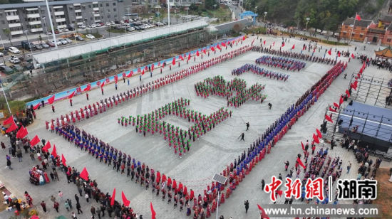 少儿方阵的500名小朋友手持彩纸,在场地中央整齐排列组成“江华70”字样。熊洋 摄 少儿方阵的500名小朋友手持彩纸,在场地中央整齐排列组成“江华70”字样。熊洋 摄